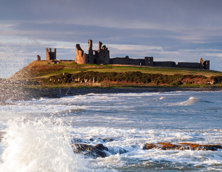 Castle with waves breaking in foreground