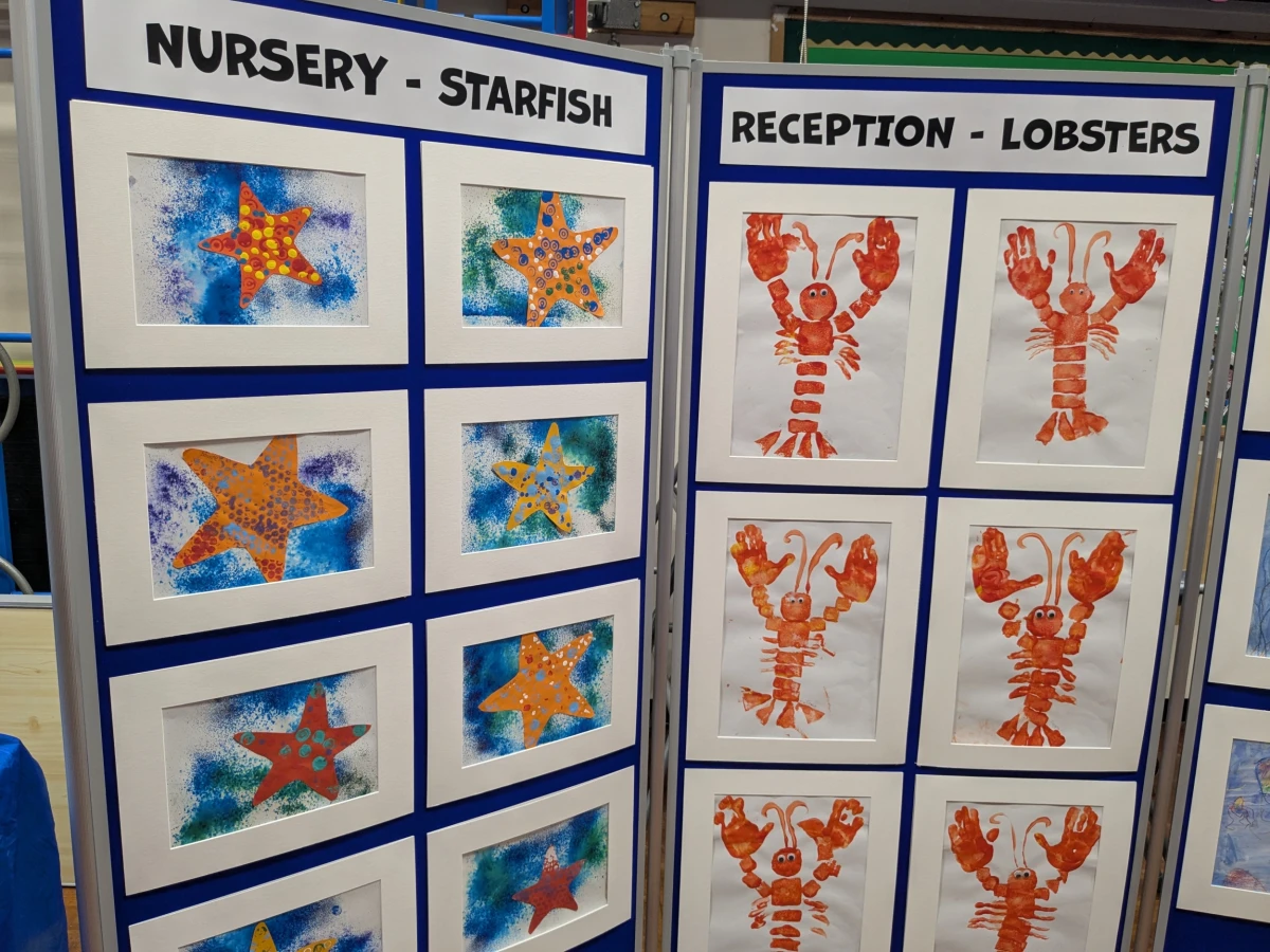Children's paintings of starfish and lobsters