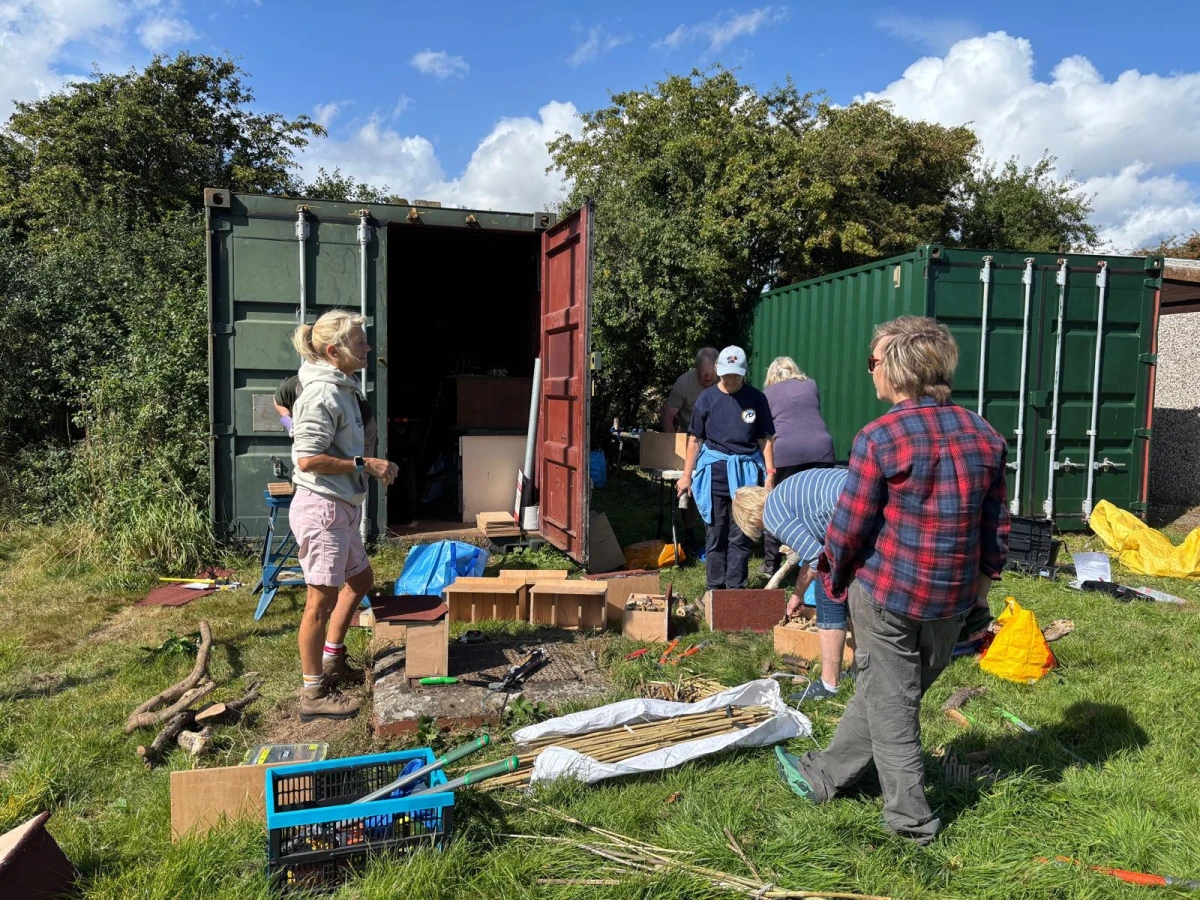 People with materials and tools to build bee homes