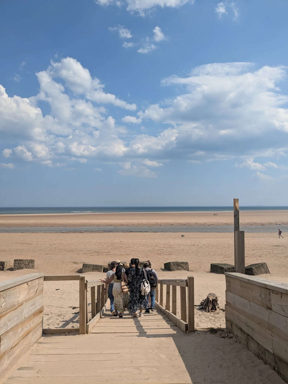 People walking onto the beach